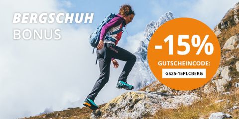 Eine Person wandert in Wanderausrüstung und Rucksack einen felsigen Bergpfad hinauf. Der Text auf dem Bild erwähnt „BERGSCHUH BONUS“, „-15% GUTSCHEINCODE: GS25-15PLCBERG“. Im Hintergrund sind ein bewölkter Himmel und felsige Gipfel zu sehen.